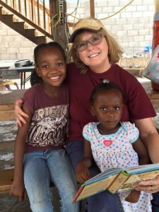 Haiti Pastor Cindy reading with girls